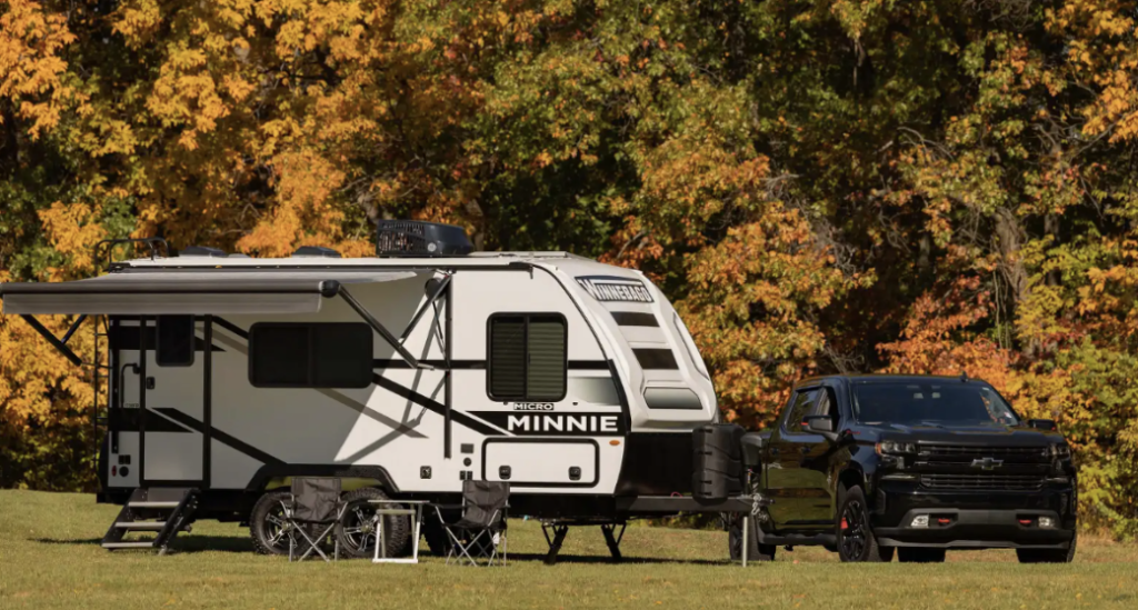 A Chevy pickup truck towing a Winnebago Micro Minnie RV