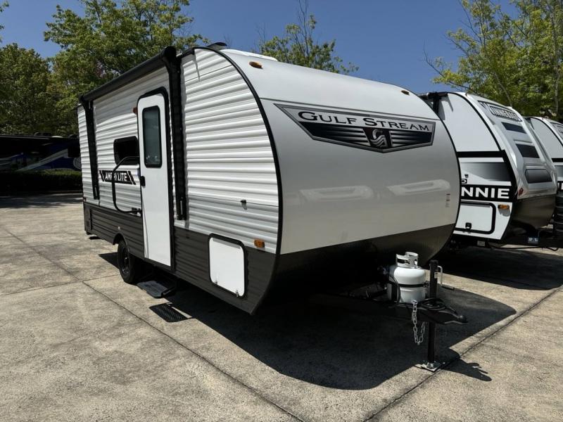 A parked Gulf Stream travel trailer on a lot.