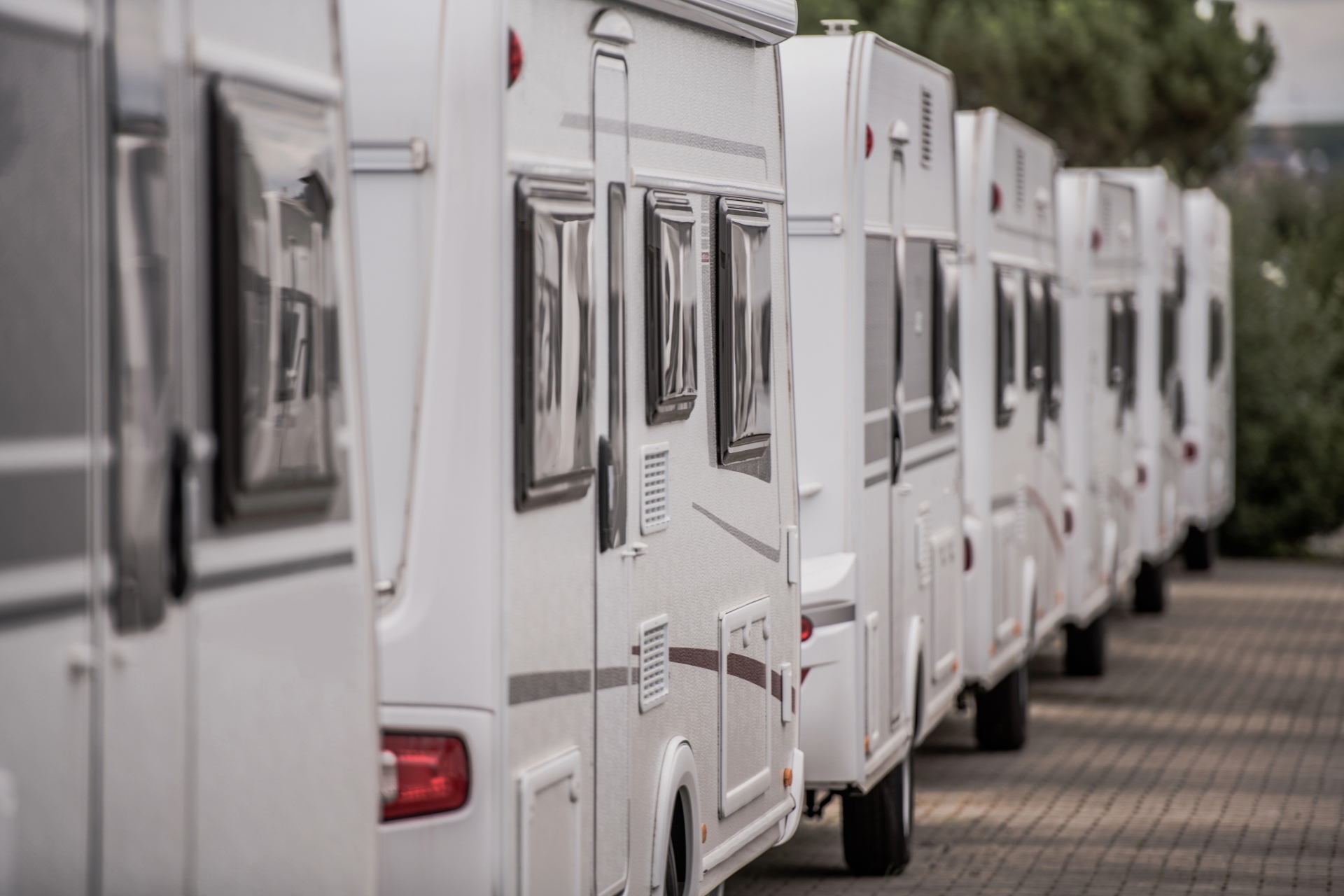 A close up row of RVs at a dealership.