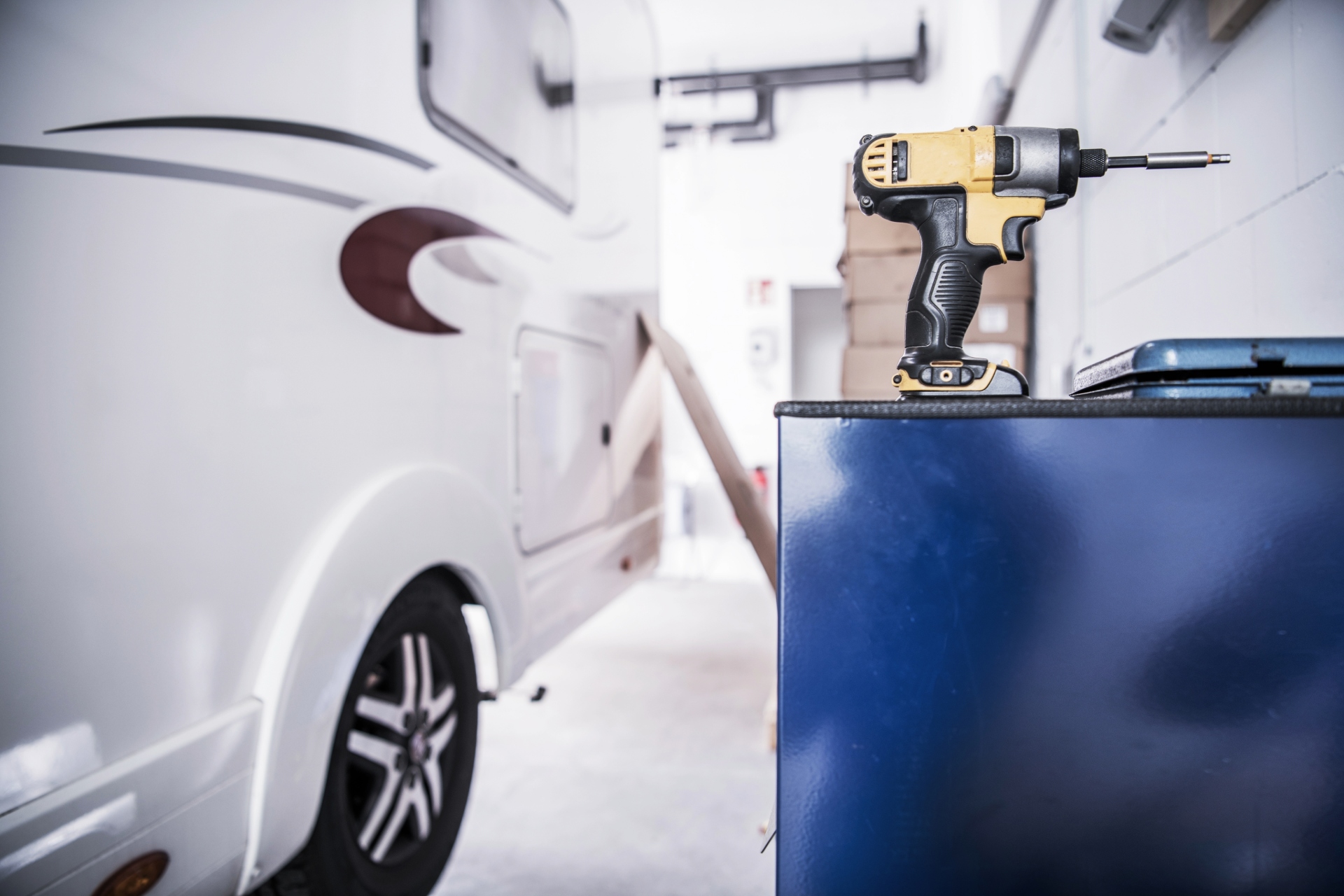 An RV camper next to a power tool before service